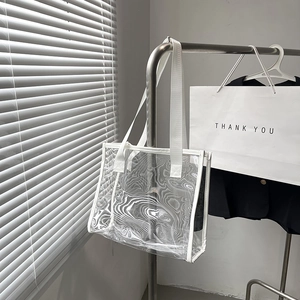 Transparent PVC tote bag with white fabric straps and topographic pattern finish
