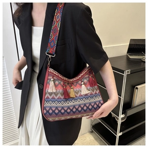 Close-up of Bohemian crossbody bag featuring woven geometric patterns and colorful tassels
