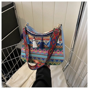 Detail of bohemian bag showing vibrant ethnic weaving patterns and colorful fringe tassels