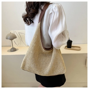 Detail view of woven shoulder bag featuring beige fiber material and brown leather straps