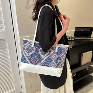 Ethnic style tote bag with geometric weave pattern and shoulder straps for daily commute