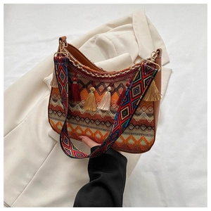 Detail of bohemian woven bag featuring colorful geometric patterns and decorative tassels