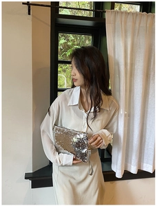Sparkly silver sequin evening clutch bag with matching handle shown in natural light