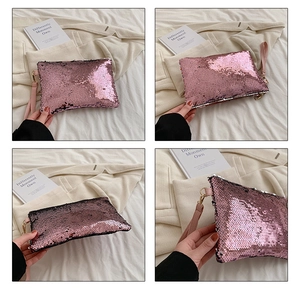 Detail of pink sequin clutch evening bag showing sparkling texture and wristlet strap
