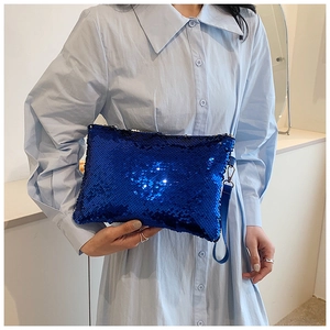 Close-up of royal blue sequined clutch bag with shimmering high-density sequins and handle
