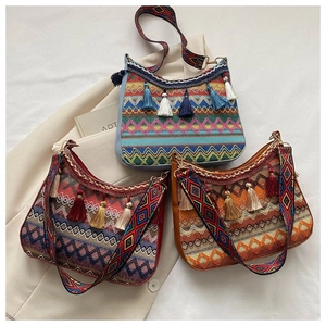 Close-up of Bohemian knit shoulder bags featuring colorful jacquard and fringe tassels