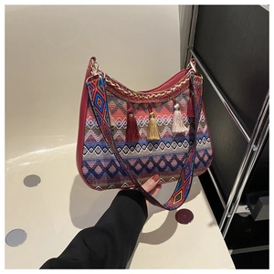 Detail of bohemian woven handbag with colorful geometric patterns and decorative tassels