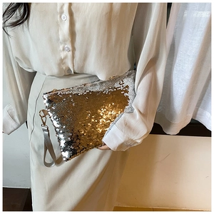 Detail of silver and gold sequin clutch bag with metallic zipper and leather wristlet