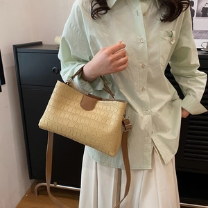 Chic cream crocodile embossed tote bag with brown straps and silver hardware detail