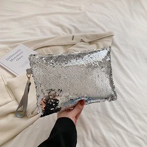 Close-up of silver sequin evening bag with high-density sparkling round sequins