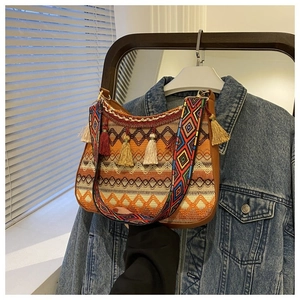 Detail of bohemian jacquard woven bag with colorful tassels and geometric strap