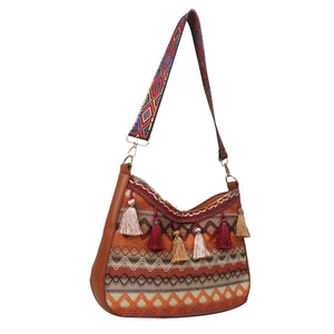 Close-up of bohemian woven shoulder bag with colorful fringe tassels and ethnic strap