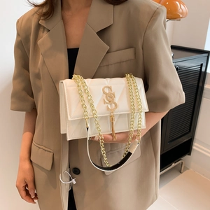 Elegant white quilted crossbody bag with gold chain strap and stylish fringe tassel
