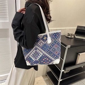 Ethnic woven tote bag with geometric patterns and white leather handles for women
