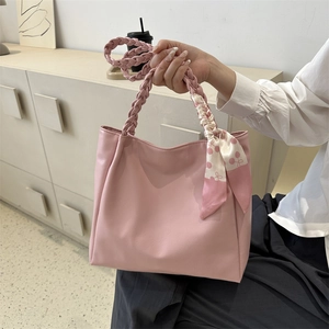 Pink PU leather tote bag with woven handles and a cherry pattern silk scarf decoration