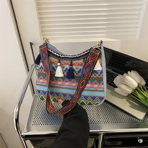 Bohemian woven crossbody bag with colorful fringe and wide ethnic shoulder strap