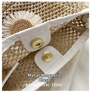 Detail showing the magnetic snap closure and daisy decor on a woven bucket bag