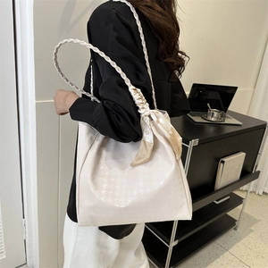 Chic beige houndstooth tote bag with woven shoulder strap and decorative silk scarf