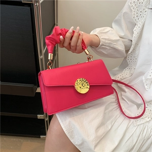 Chic magenta pleated handle handbag with a round golden buckle and shoulder strap