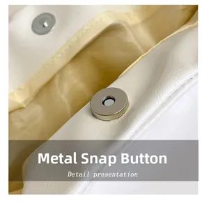 Détail du fermoir magnétique de qualité sur un sac à bandoulière en cuir blanc