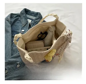 Interior view of straw tote bag showing large capacity for wallet, phone and umbrella