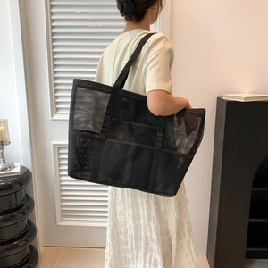 Bolso tote minimalista de malla negra con interior espacioso y correa de hombro ancha