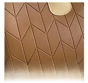 Close-up of geometric diamond quilted stitching on caramel leather shoulder bag detail