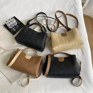 Quilted women's crossbody handbags in four colors with V-stitch pattern and top handles