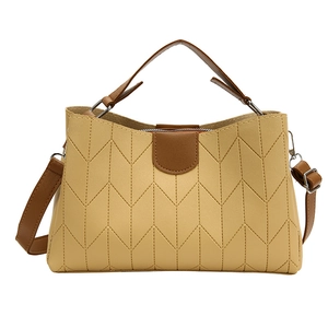 Chic yellow chevron quilted shoulder bag with contrast brown handles and silver hardware