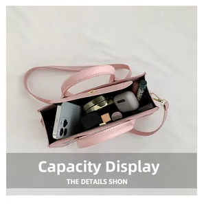 Top view of pink rivet crossbody bag interior showing storage for phone and makeup