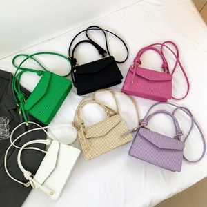 Minimalist square crossbody bags with woven texture in six vibrant colors on white fabric