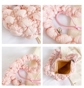 Detail showing pink puffy quilted texture with bubble fabric and secure zipper closure