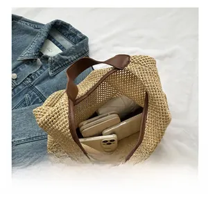 Top view of beige woven tote bag interior showing capacity for phone, wallet and umbrella