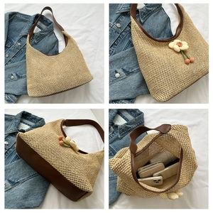 Detail view of woven straw tote bag with brown leather straps and spacious interior lining