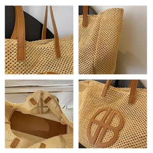 Detail view of woven straw tote bag featuring leather handles and interior space