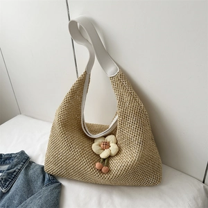 Chic straw tote bag with floral accents and white leather straps for summer style