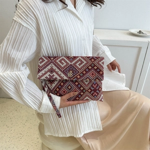 Ethnic style woven geometric clutch bag with gold clover clasp and wrist strap for women