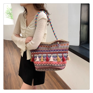 Detail of colorful woven tote bag with multi-colored fringe and ethnic patterns