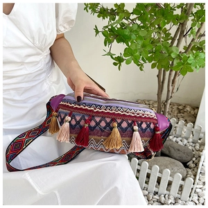 Détail du sac bandoulière bohème avec glands colorés et motifs géométriques tissés