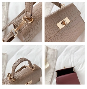 Detailed close-up of khaki croc-effect mini bag featuring gold twist lock and interior lining