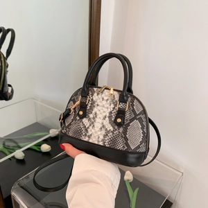 Women snake skin pattern shell bag with black faux leather and gold hardware detail