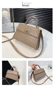 Detailed close-up of khaki faux crocodile texture leather bag with gold hardware