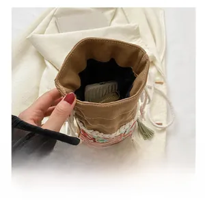 Detailed view of canvas bucket bag interior showing capacity for phone and wallet