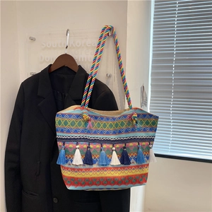 Ethnic bohemian woven tote bag with colorful geometric patterns and long tassels