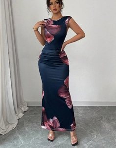 Close-up of ruched waist details and large floral print on a slim fit maxi dress