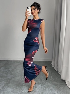 Detail of slim-fit navy sleeveless dress featuring floral print and side ruching