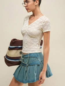 Elegant white lace V-neck short sleeve top with pleated details for summer beach style