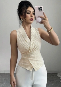 Detailed view of yellow striped sleeveless shirt with cross-wrap waist and lapel collar