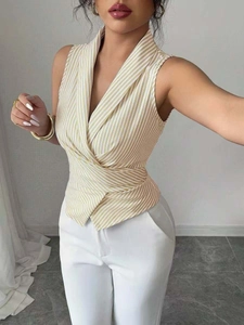 Detail of yellow striped sleeveless V-neck wrap top with flattering waist tie for women
