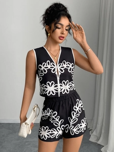 Detail of floral V-neck vest and shorts set featuring white piping and button closure